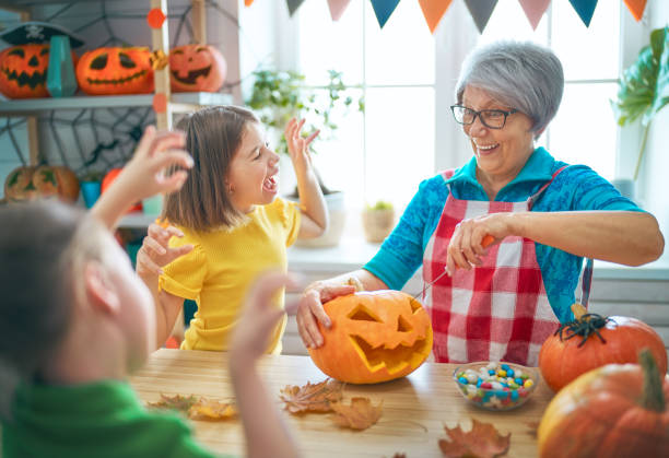 Happy family celebrating Halloween. Grandmother, mother and children at home.