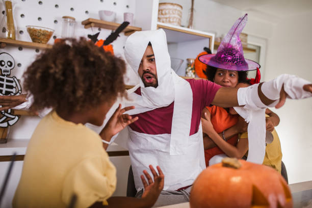 Happy family preparing for Halloween, having fun.