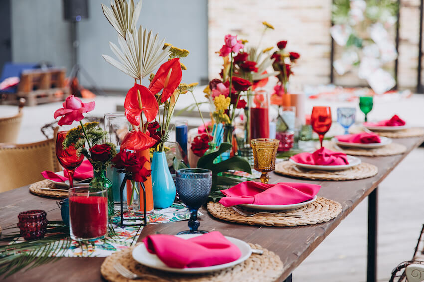 table decorated with flowers and pink napkins