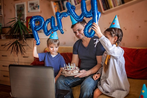 cheerful father holding cake sitting with kids