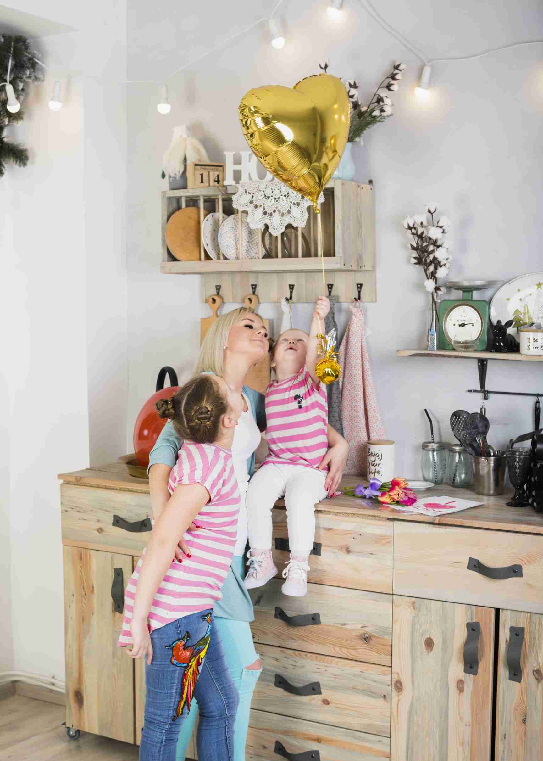 mother daughters with heart balloon kitchen