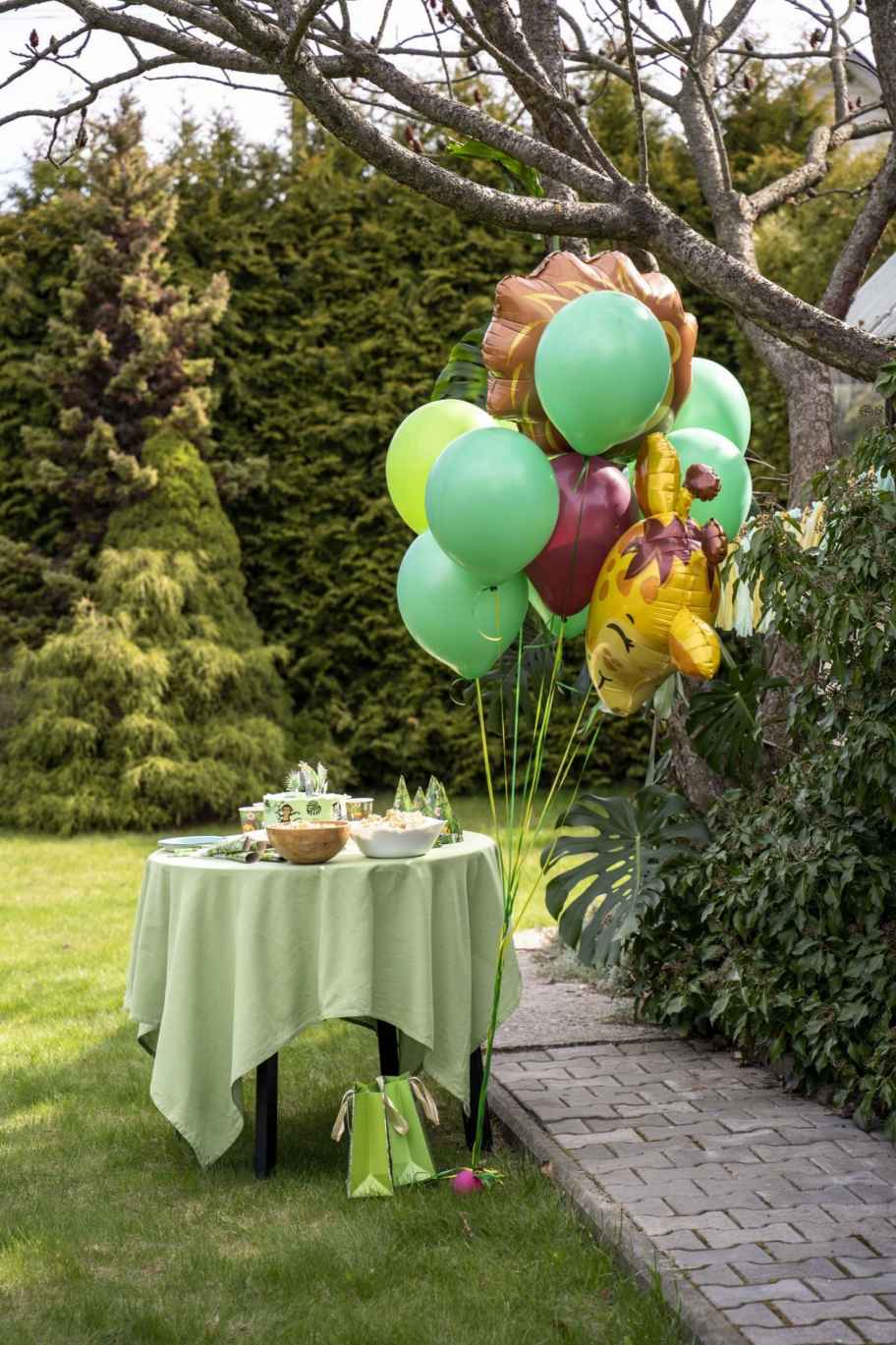 beautiful green jungle themed party booth