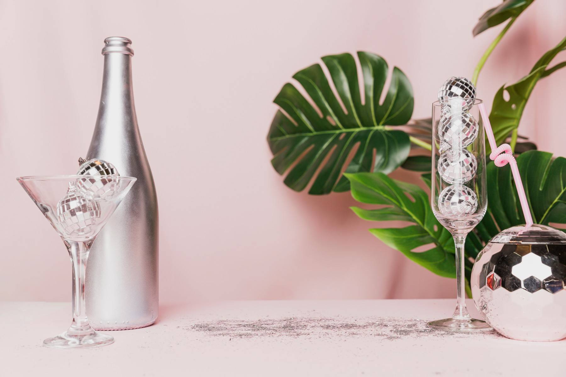 disco balls champagne glasses monstera plant