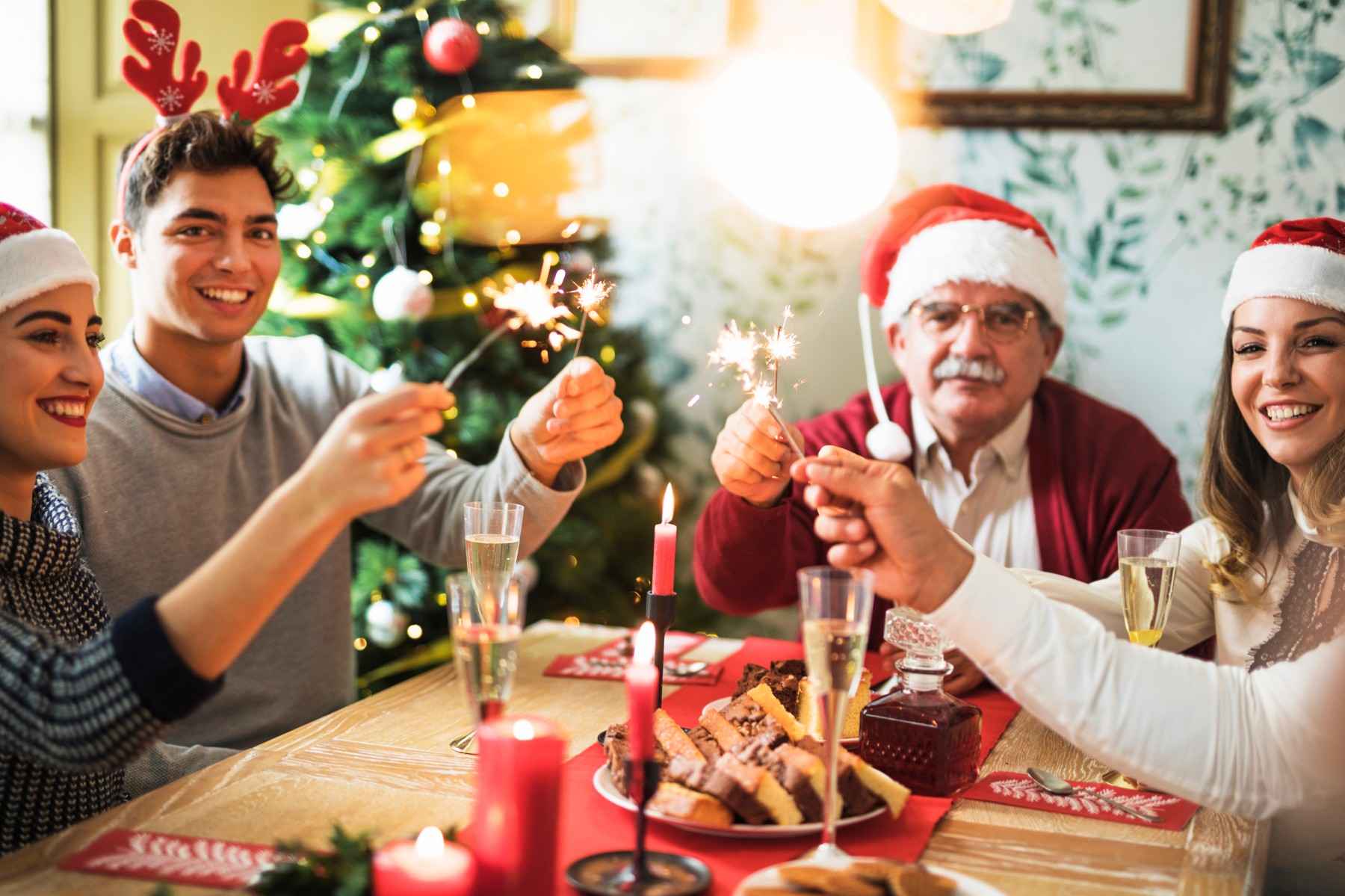 Chsirtmas celebration family with burning bengal fires festive table