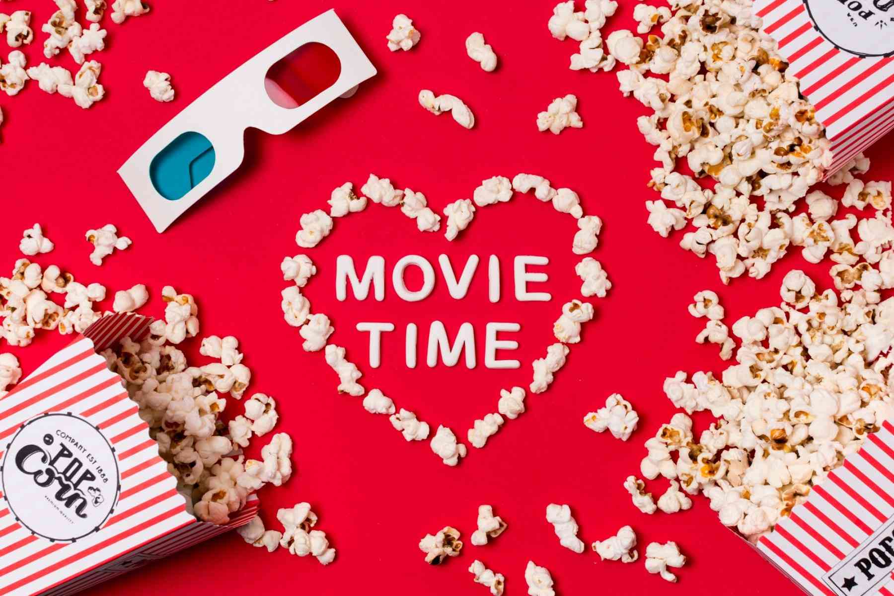 3d glasses popcorn spilled from box with movie time text heart shape red backdrop