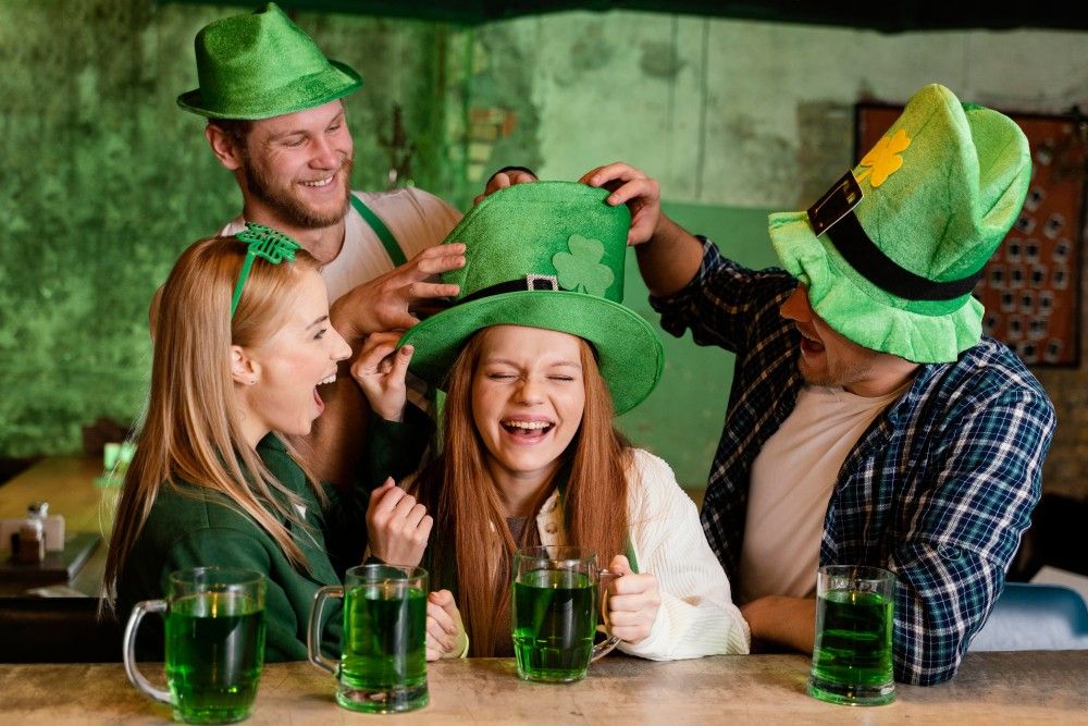 friends celebrating st patrick s day together with drinks